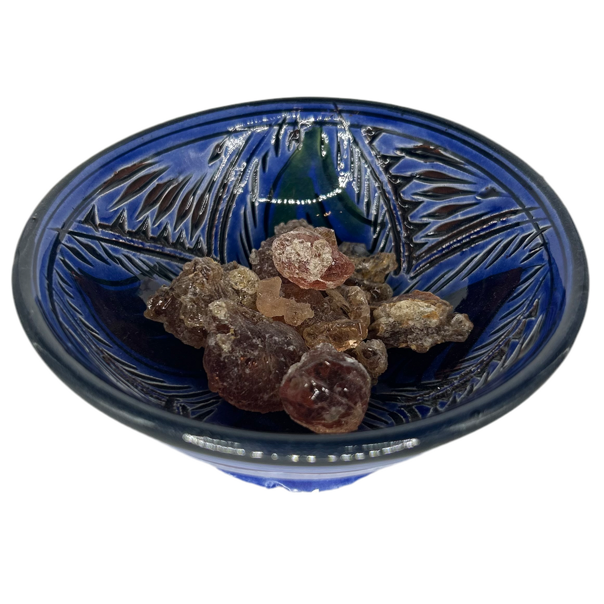 A bowl filled with golden-brown gum arabic beads